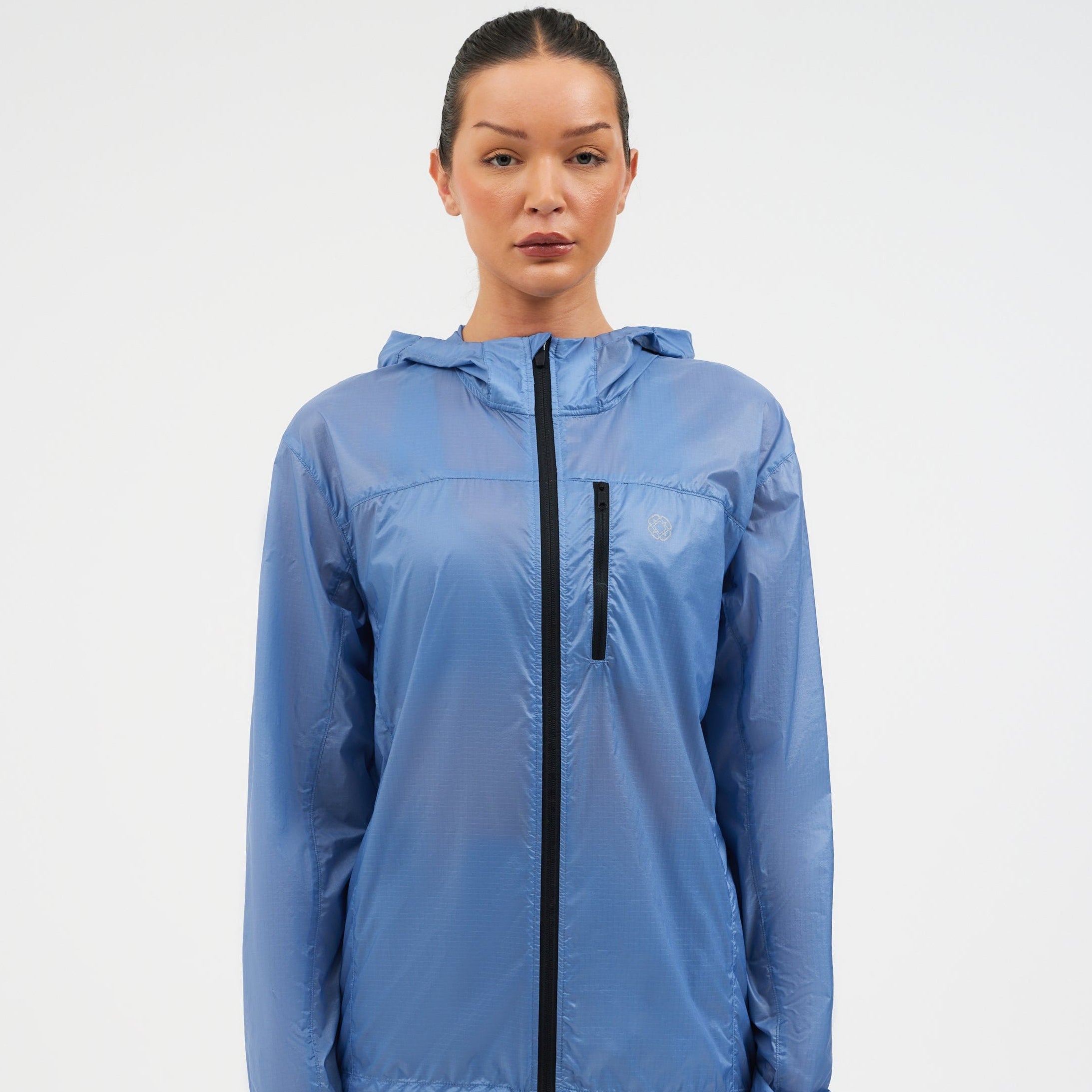 Woman wearing a blue raincoat on a white background